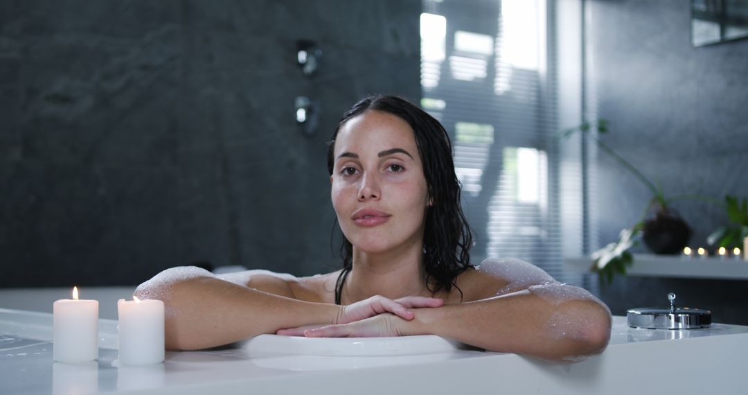 Woman Relaxing in a Bathtub with Candles - Free Images, Stock Photos and Pictures on Pikwizard.com