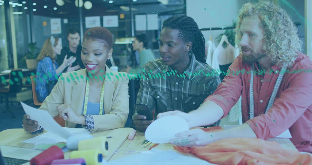 Diverse Designers Collaborating on Fashion Project in Modern Office