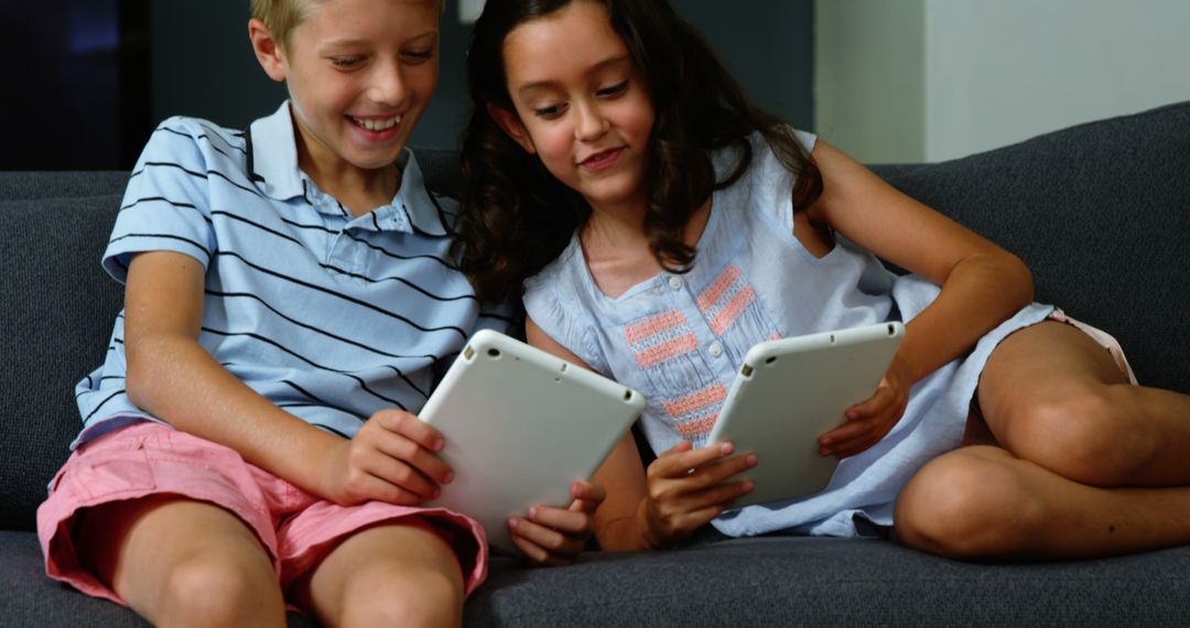 Happy Kids Using Tablets on Couch - Free Images, Stock Photos and Pictures on Pikwizard.com