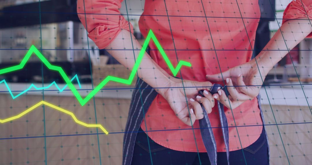 Retail Worker Tying Apron Amid Business Data Graphics