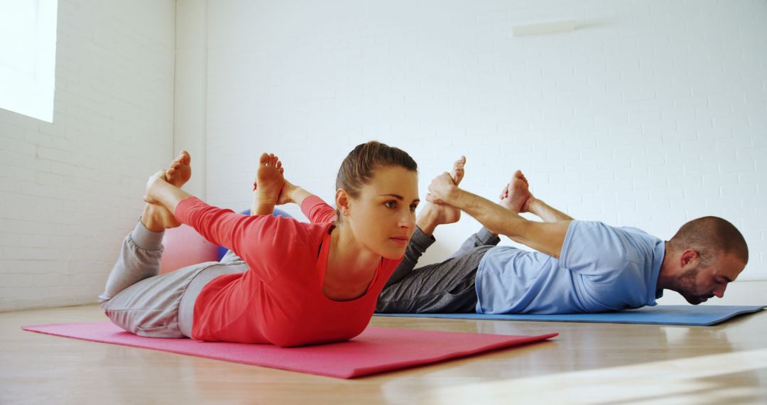 Group Practicing Bow Pose in Yoga Class - Free Images, Stock Photos and Pictures on Pikwizard.com