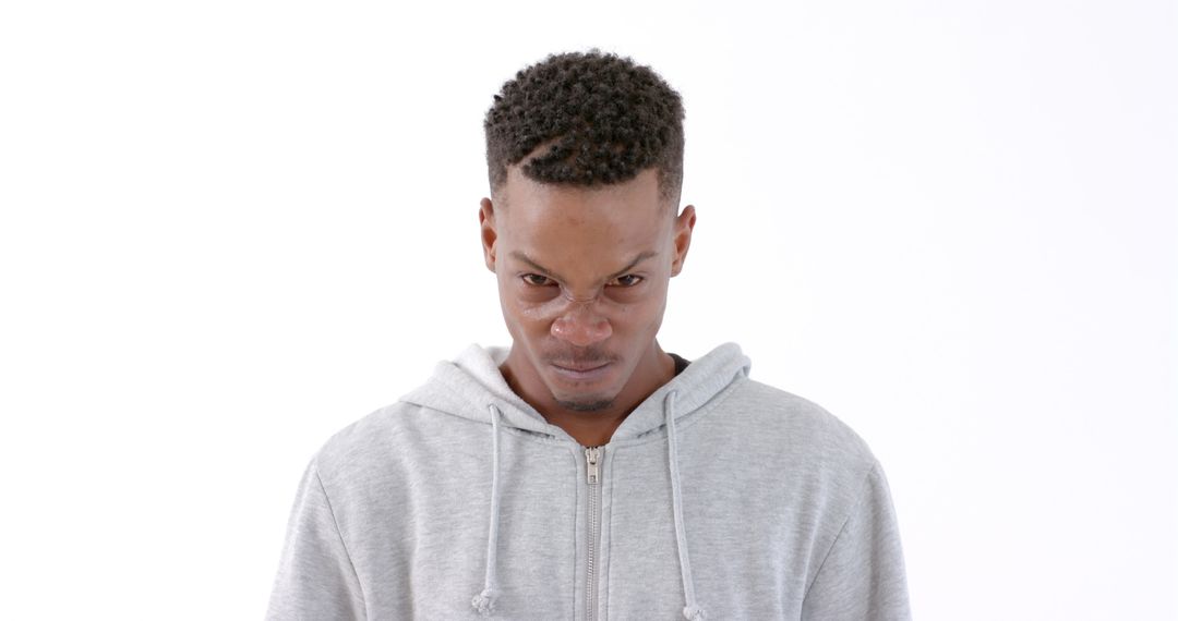 Man in Gray Hoodie with Focused Expression