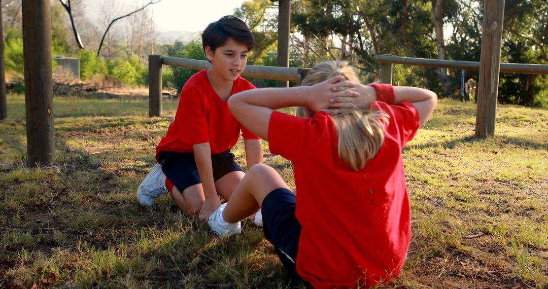 Kids Exercising Outdoors in Bright Red Sports Uniforms - Free Images, Stock Photos and Pictures on Pikwizard.com