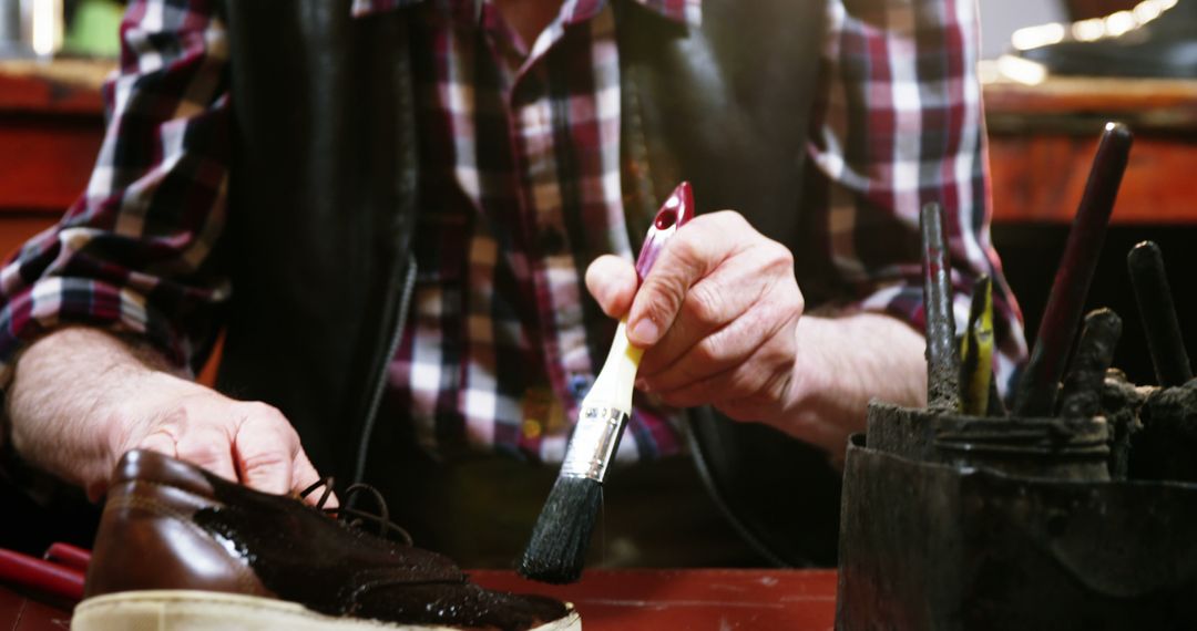 Man Polishing Shoes in Workshop - Free Images, Stock Photos and Pictures on Pikwizard.com