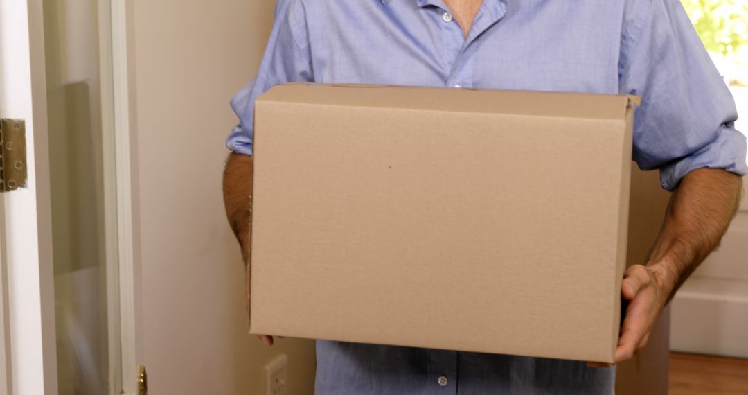 Person Holding Cardboard Box Home Delivery Concept - Free Images, Stock Photos and Pictures on Pikwizard.com