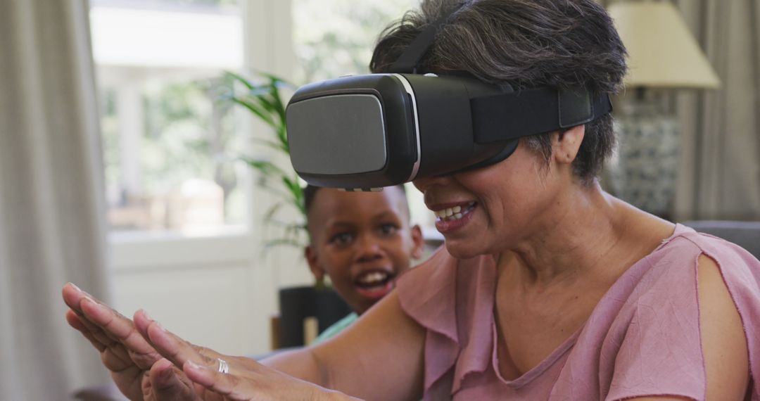 Senior Woman Enjoying Virtual Reality with Grandson at Home - Free Images, Stock Photos and Pictures on Pikwizard.com