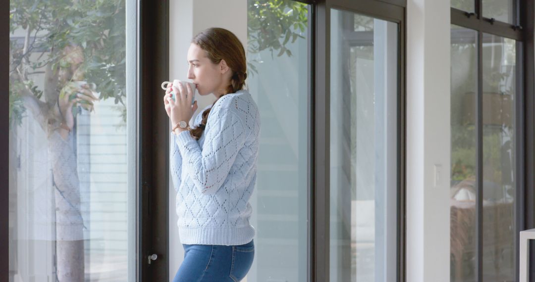 Thoughtful Woman Sipping Coffee by Home Window - Free Images, Stock Photos and Pictures on Pikwizard.com