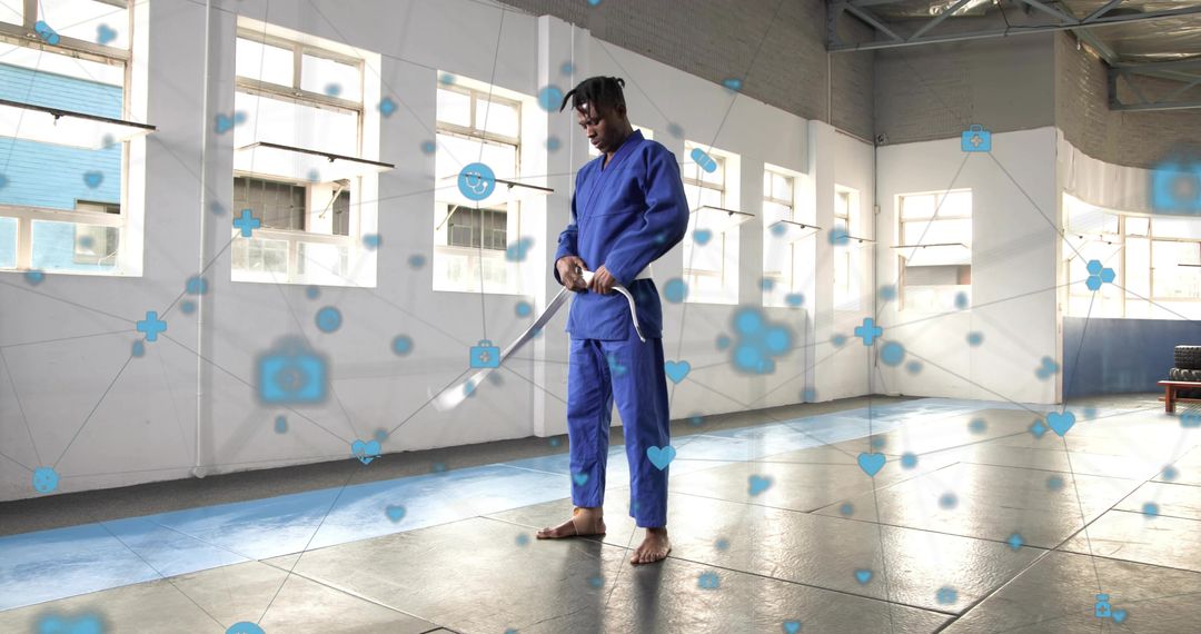 Martial artist adjusting stance with bokken in modern dojo with digital network overlay