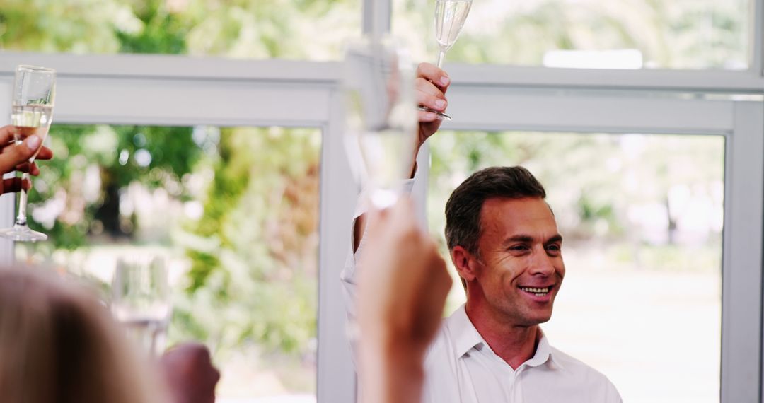 Businessman Leading a Toast at Celebration Event - Free Images, Stock Photos and Pictures on Pikwizard.com