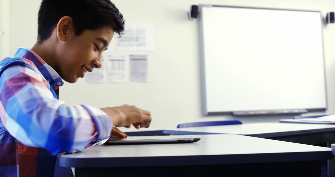 Schoolboy Engaging with Digital Tablet in Classroom