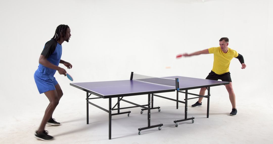 Dynamic Table Tennis Match in White Studio Setting