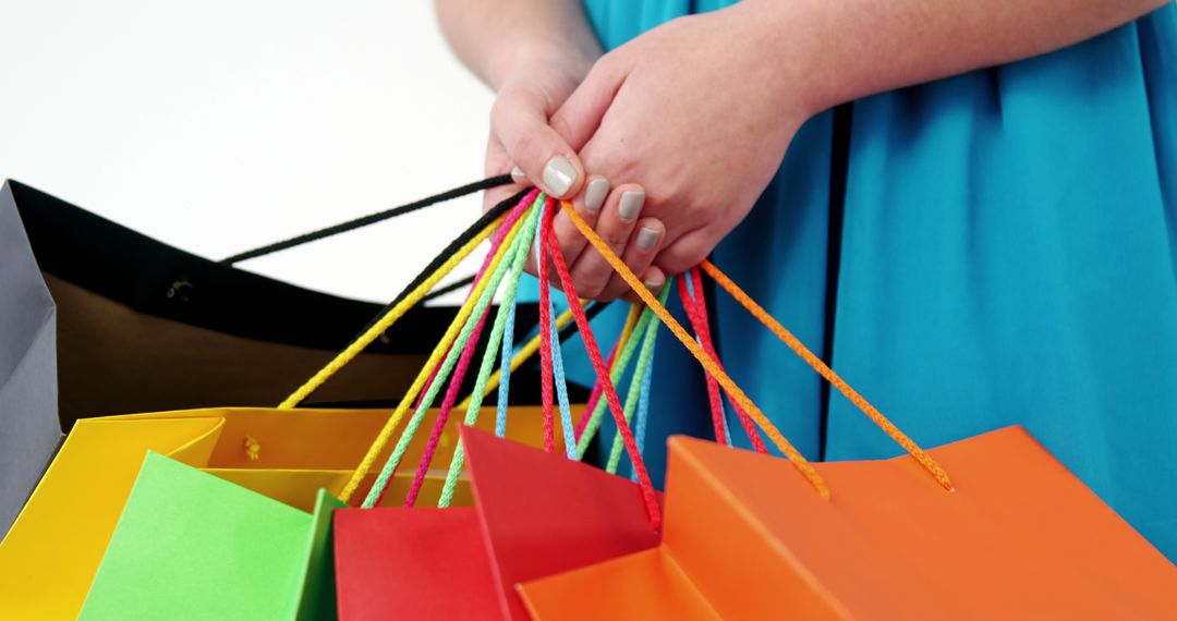 Close-Up of Woman Holding Vibrant Shopping Bags - Free Images, Stock Photos and Pictures on Pikwizard.com