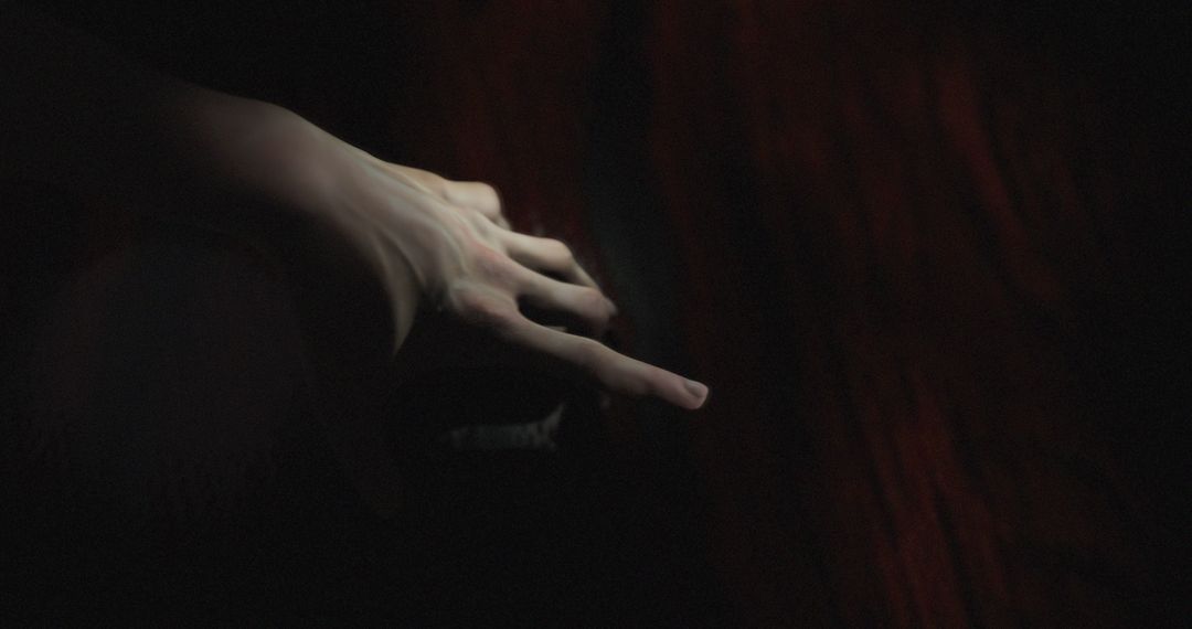 Mysterious Hand Reaching in Darkness