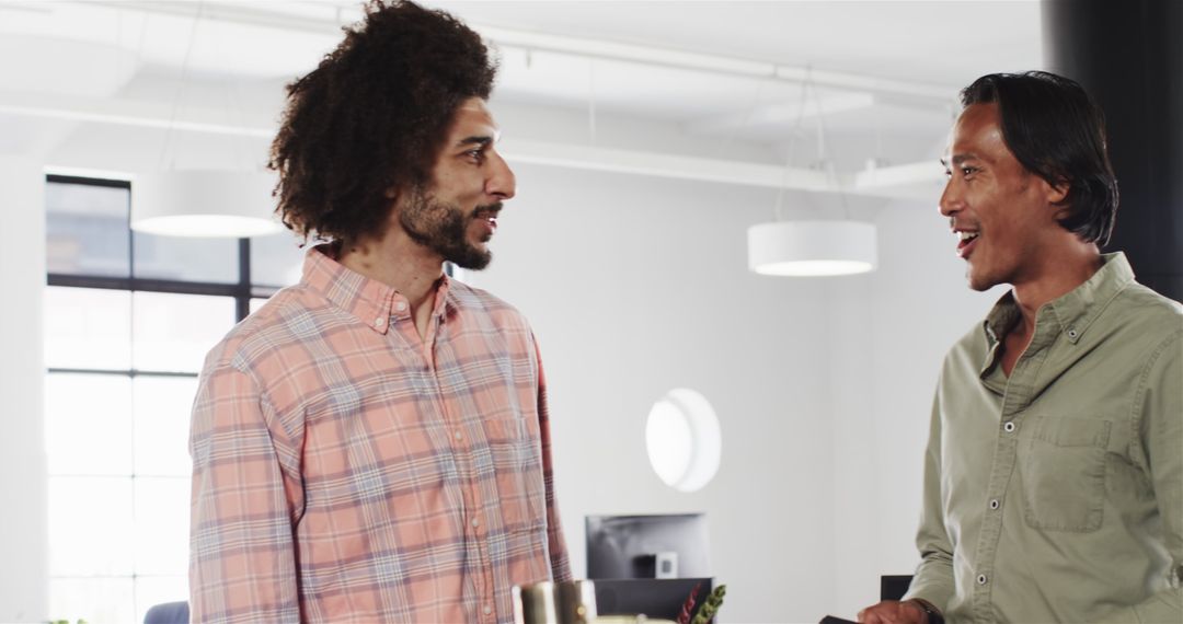 Diverse Colleagues Engaging in Positive Discussion at Modern Office