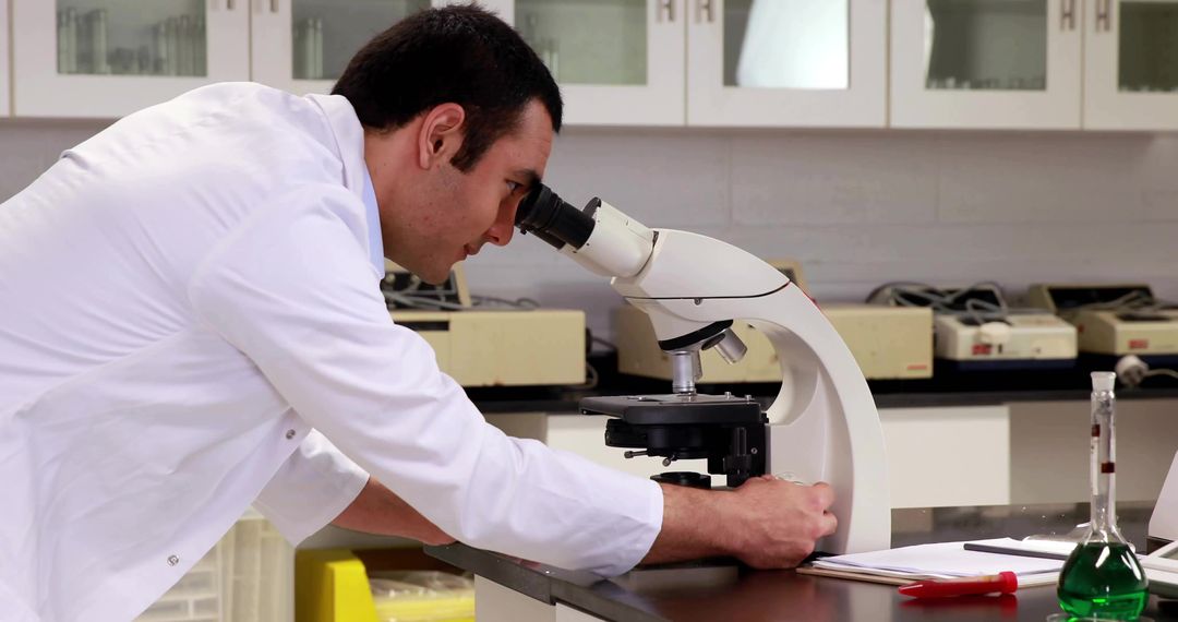 Scientist Analyzing Samples with Microscope in Laboratory
