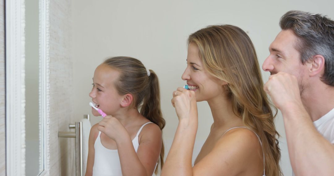 Happy Family Brushing Teeth in Bright Bathroom Setting - Free Images, Stock Photos and Pictures on Pikwizard.com