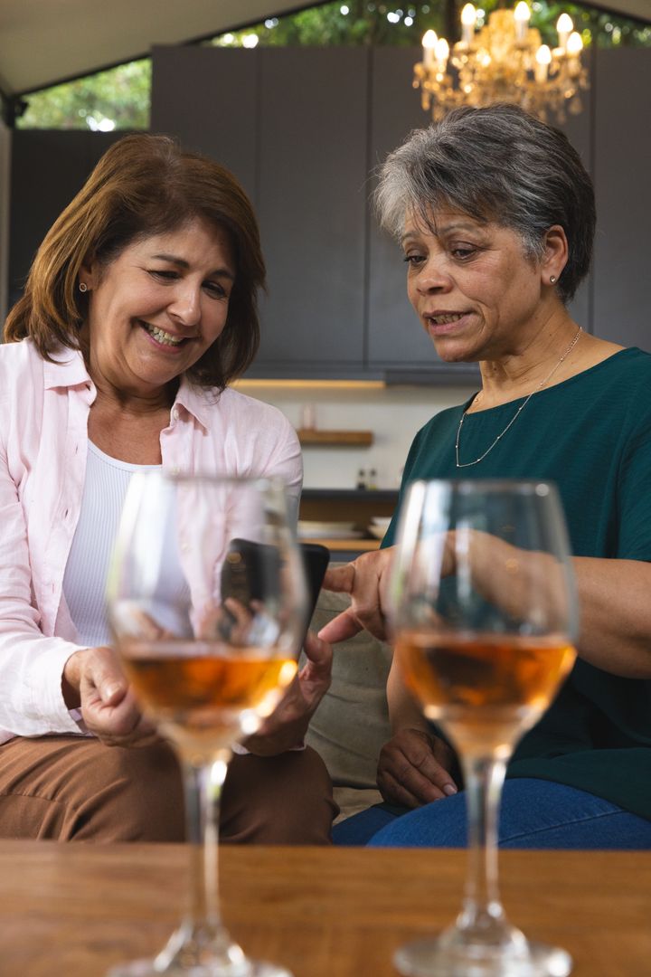 Diverse Friends Enjoying Relaxing Moment with Wine and Smartphone