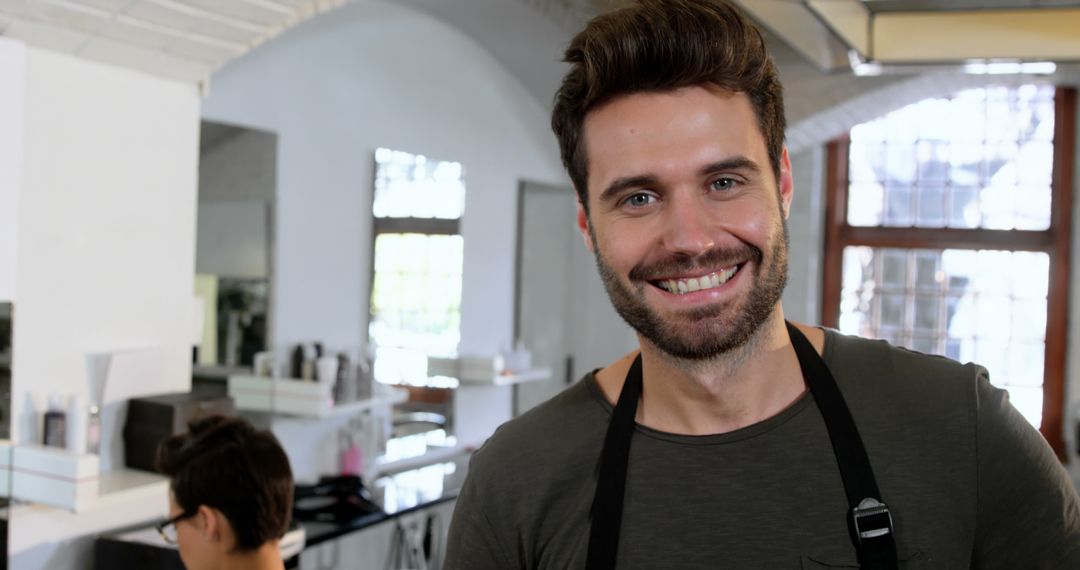 Cheerful Male Hairdresser Smiling in Modern Hair Salon - Free Images, Stock Photos and Pictures on Pikwizard.com