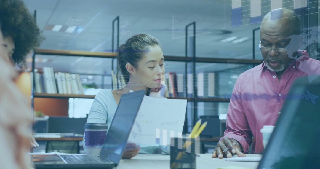 Diverse Team Analyzing Financial Data in Modern Office Workspace