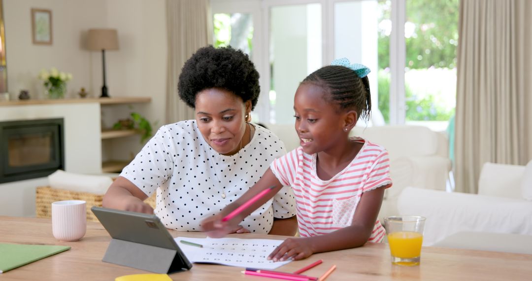 Mother and Daughter Sharing Learning Moment with Tablet