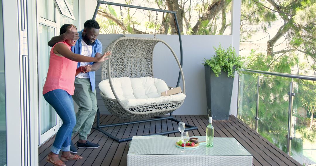 Couple Enjoying Day on Stylish Patio with Hanging Chair