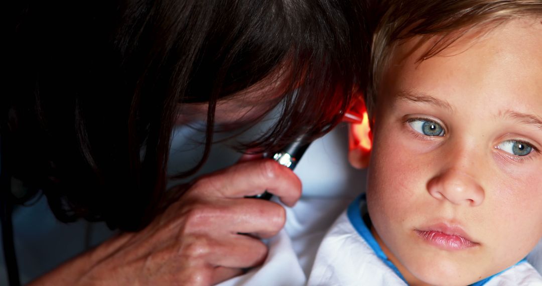 Doctor Examining Young Boy’s Ear with Otoscope - Free Images, Stock Photos and Pictures on Pikwizard.com