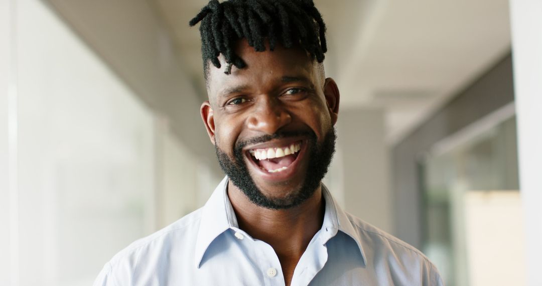 Confident Smiling Man in Office Environment
