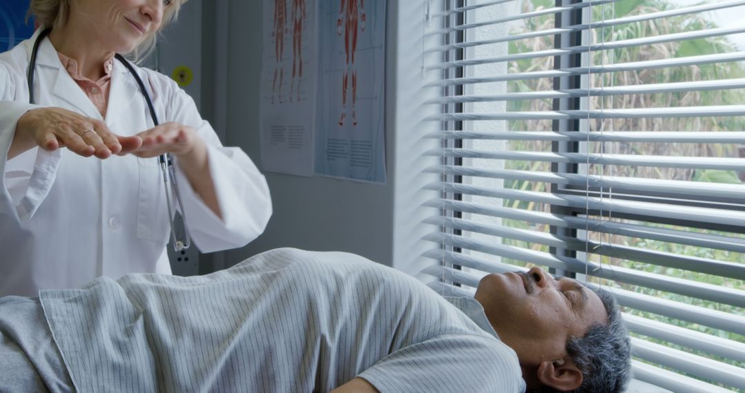 Reiki Practitioner Healing Patient in Medical Office Next to Window with Blinds - Free Images, Stock Photos and Pictures on Pikwizard.com