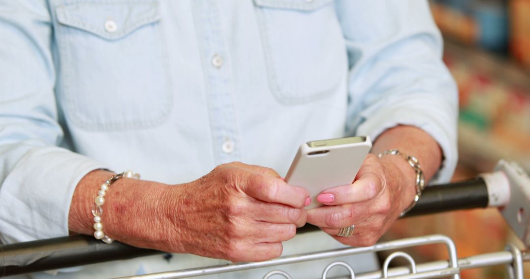 Elderly Woman Using Smartphone While Grocery Shopping - Free Images, Stock Photos and Pictures on Pikwizard.com