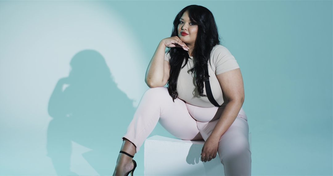 Elegant Plus Size Model with Black Suspenders in Minimalist Studio