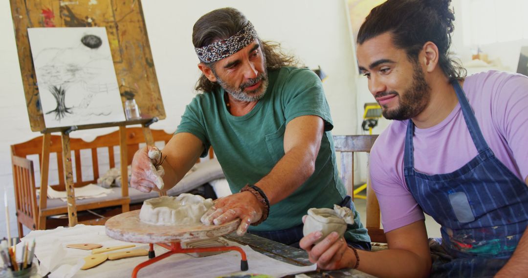 Instructor Teaching Student Pottery In Art Studio - Free Images, Stock Photos and Pictures on Pikwizard.com