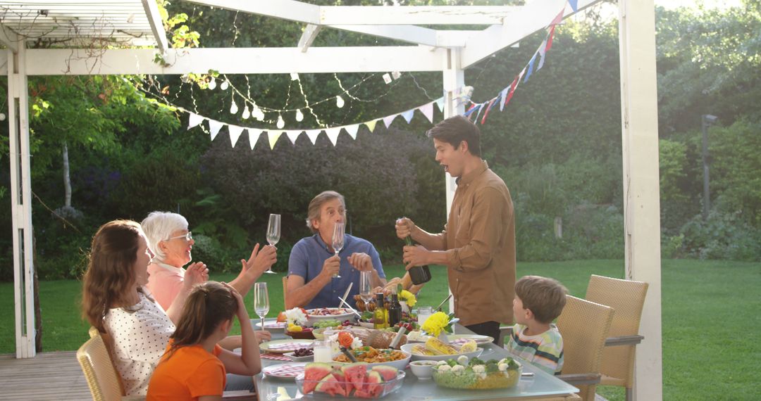 Cheerful Family Gathering Around Outdoor Dining Table - Free Images, Stock Photos and Pictures on Pikwizard.com