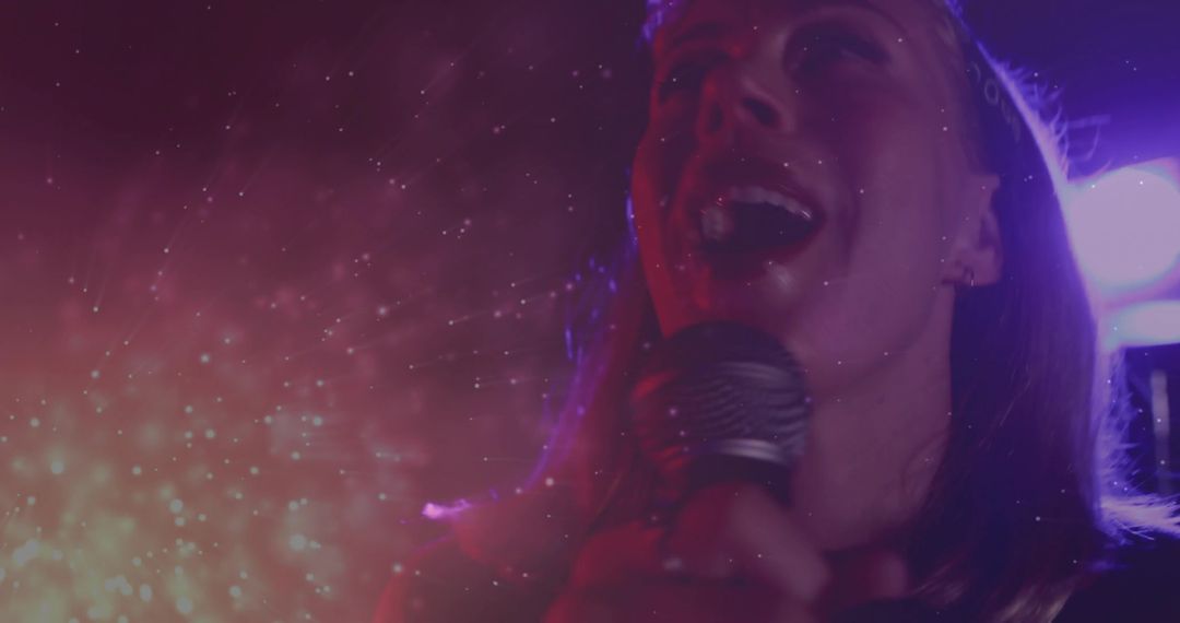 Dynamic Performer Singing Captivating Audience with Vibrant Lighting Effects