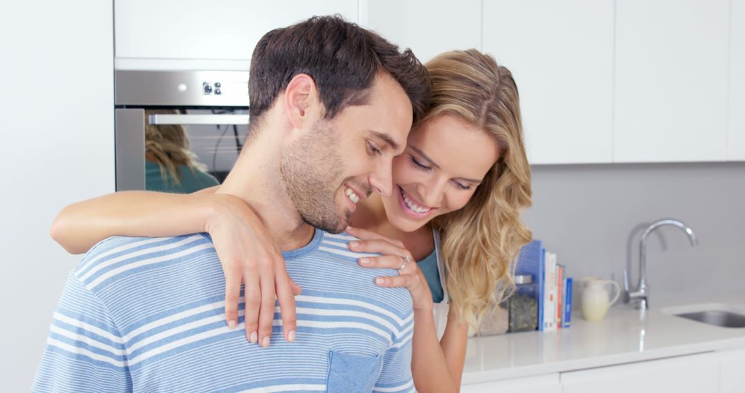 Joyful Couple Smiling Together in Bright Home Kitchen