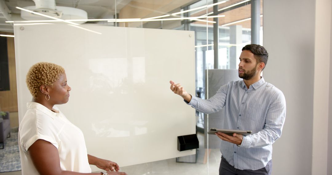 Diverse Teammates Collaborating in Modern Office with Tablet