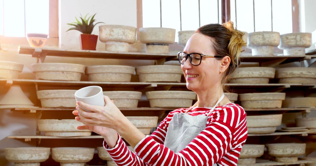 Female Artisan Inspecting Handmade Ceramic Bowl in Studio - Free Images, Stock Photos and Pictures on Pikwizard.com