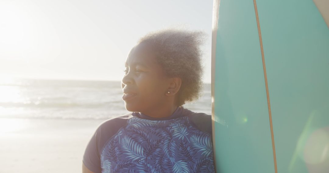 Pensive Woman with Surfboard Looking at Ocean During Sunset - Free Images, Stock Photos and Pictures on Pikwizard.com