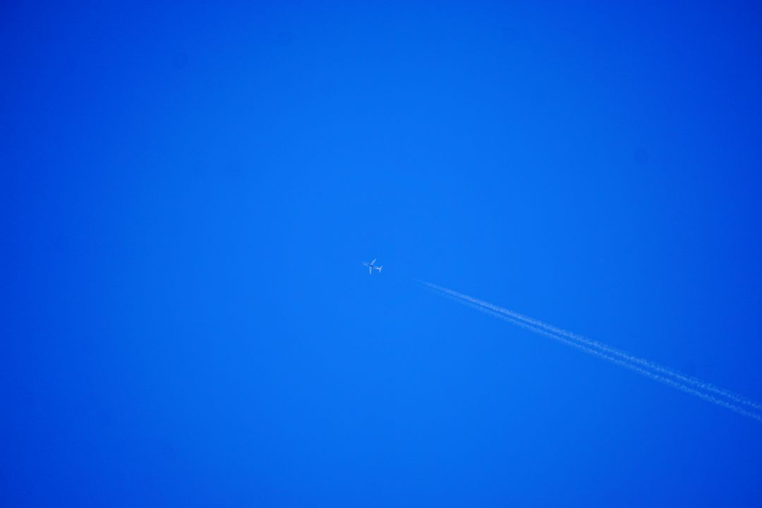 Airplane Creating Contrail in Clear Blue Sky - Free Images, Stock Photos and Pictures on Pikwizard.com