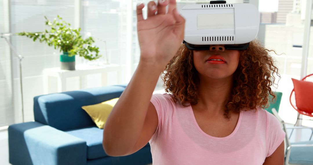 Woman Engaging in Virtual Reality Experience with VR Headset - Free Images, Stock Photos and Pictures on Pikwizard.com