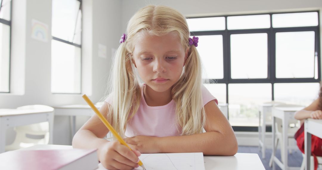 Young Girl Concentrating on Drawing in Classroom - Free Images, Stock Photos and Pictures on Pikwizard.com