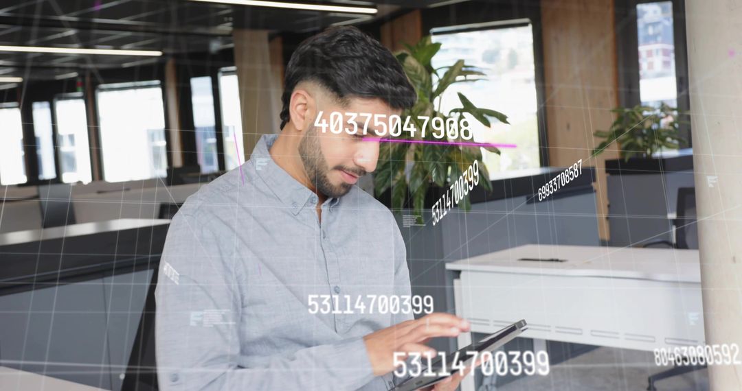 Man Reviewing Digital Data Interactions in Modern Office