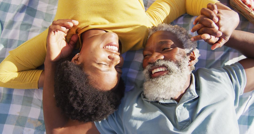 Portrait of happy african american couple having picnic on sunny beach - Free Images, Stock Photos and Pictures on Pikwizard.com
