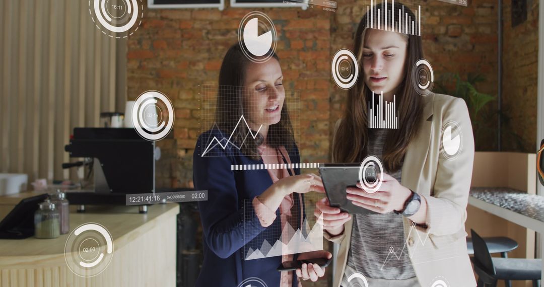 Two Businesswomen Analyzing Data on Digital Tablet