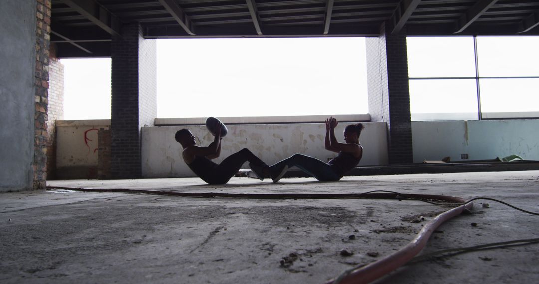 Two Men Exercising with Medicine Ball in Abandoned Building - Free Images, Stock Photos and Pictures on Pikwizard.com