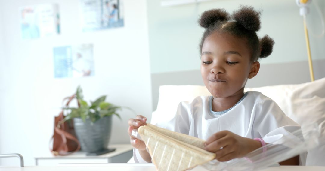 Young African American Girl Eating Sandwich in Hospital Bed - Free Images, Stock Photos and Pictures on Pikwizard.com