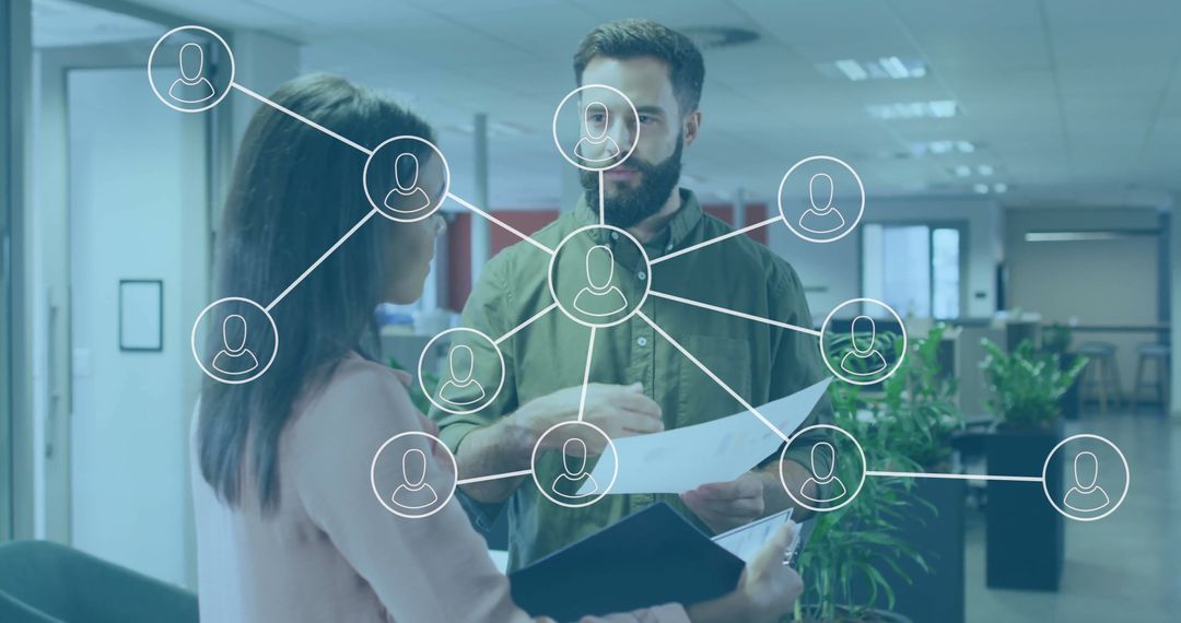 Colleagues in Office Reviewing Documents with Digital Network Graphics