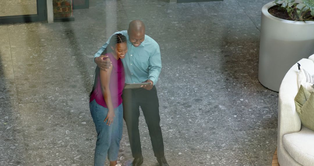 Happy Business Team Collaborating on Tablet in Modern Office