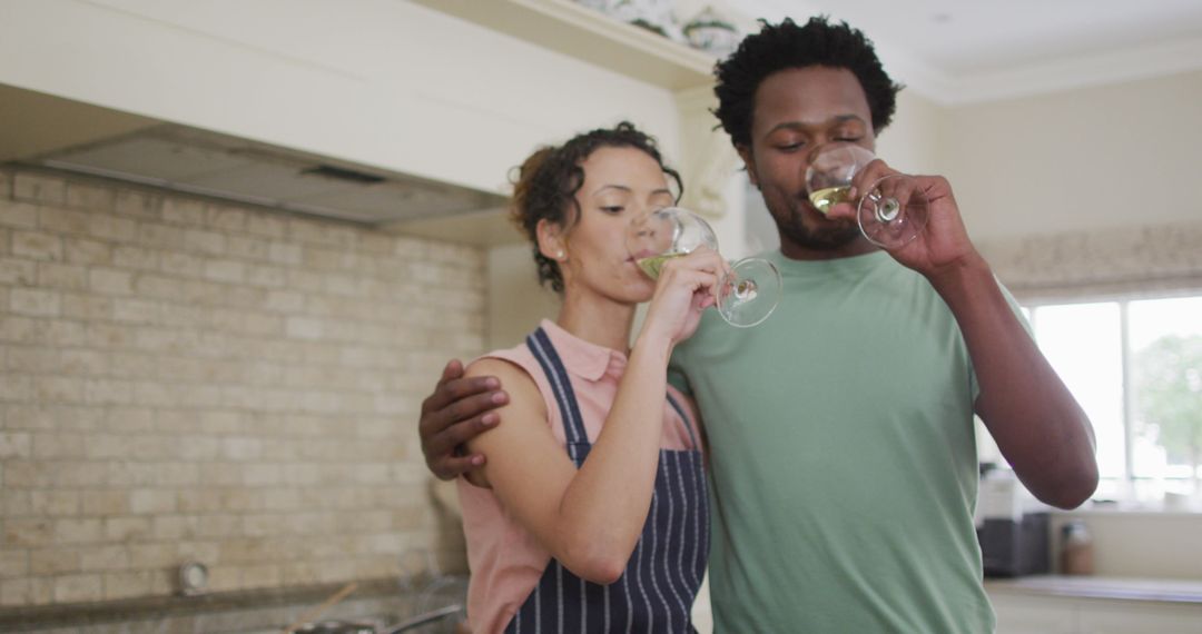 Smiling Couple Enjoying Wine in Modern Kitchen