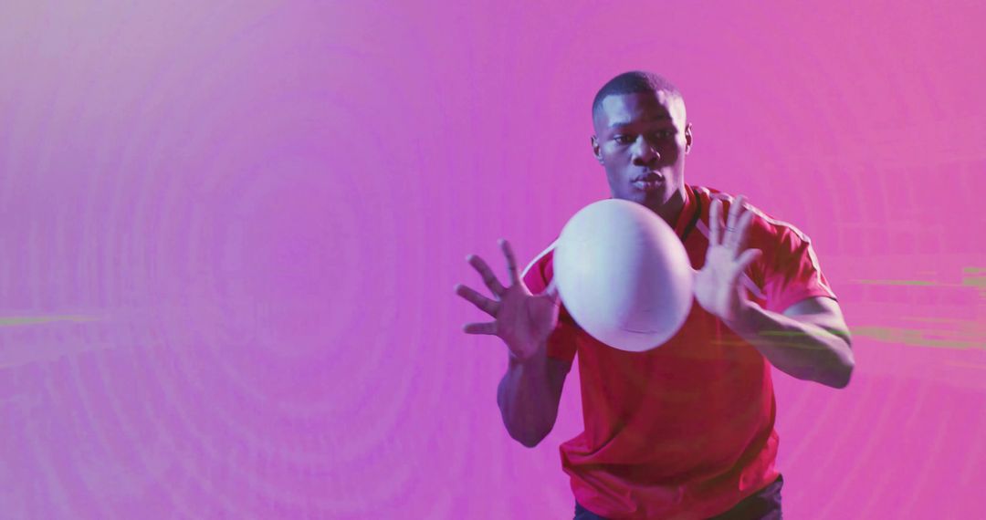 Dynamic Athlete Catches Sports Ball in Vibrant Gradient Light