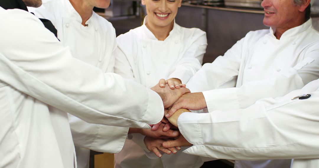 Team of chefs uniting hands in kitchen - Free Images, Stock Photos and Pictures on Pikwizard.com